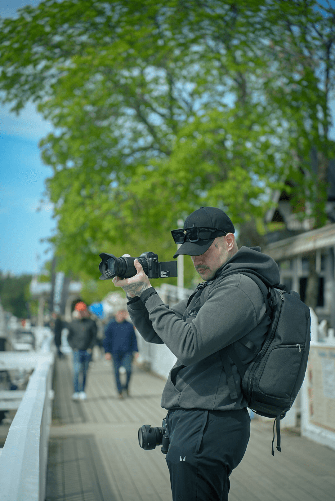 Jere Alanen eli Jeyshoots kuvaamassa kameralla puiden reunustamalla kävelytiellä.