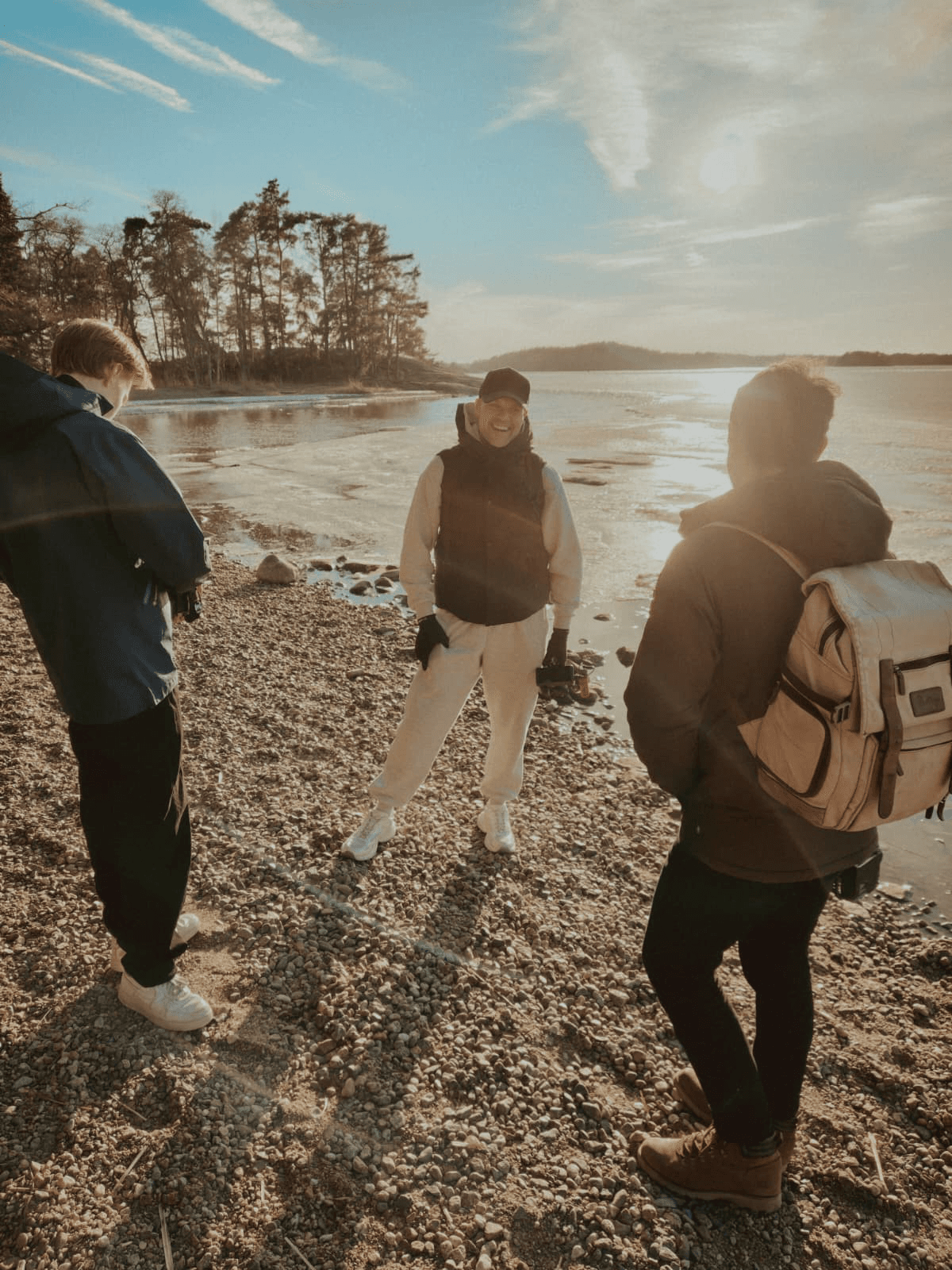 Jere Alanen eli Jeyshoots kuvausryhmän kanssa rannalla matalan auringon valossa.